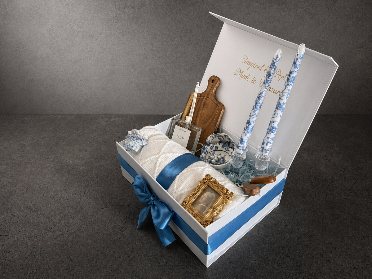 Angled open Vermeer Girl with a Pearl Earring gift box with blanket, candles and framed art