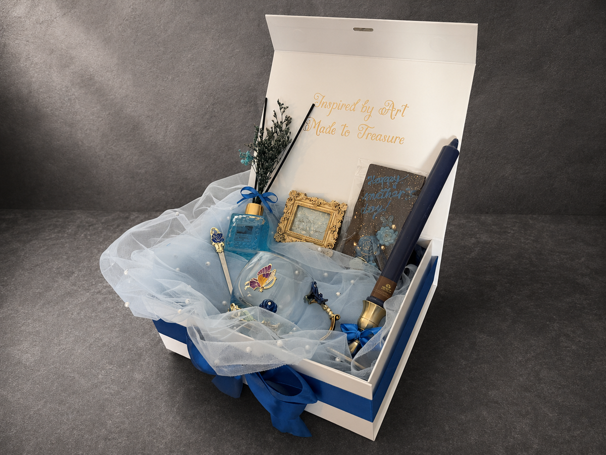 Angled Van Gogh Almond Blossom gift box with blue ribbon, white tulle and blue candle