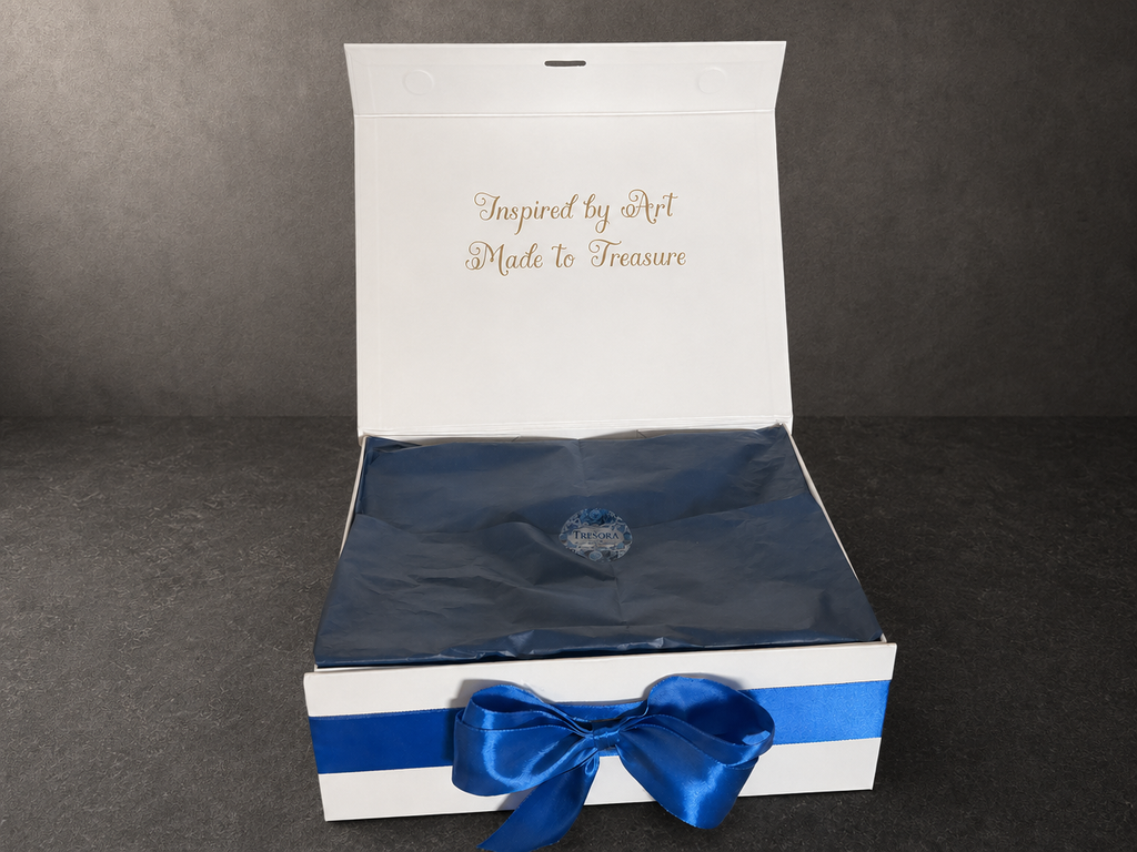 Open white Van Gogh Almond Blossom gift box with blue ribbon and tissue paper