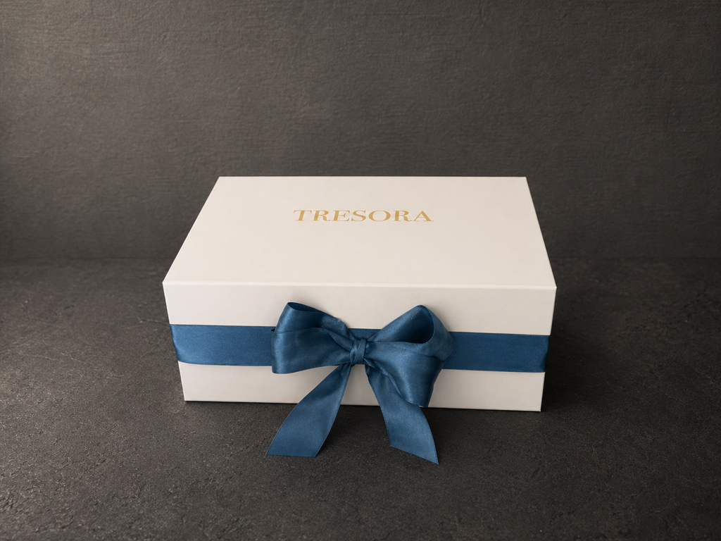 Closed white Vermeer Girl with a Pearl Earring gift box with blue ribbon and bow