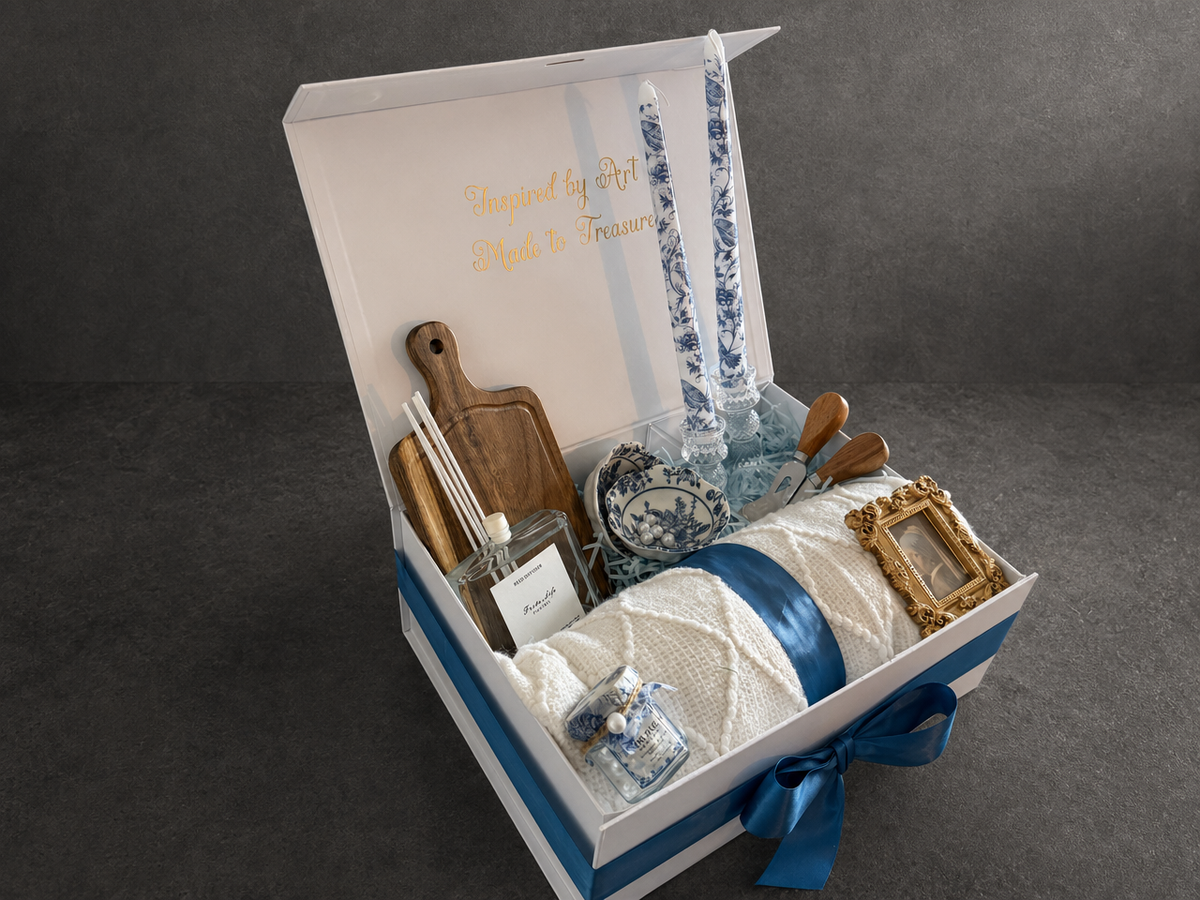 Open Vermeer Girl with a Pearl Earring gift box showing throw blanket, blue candles and framed art